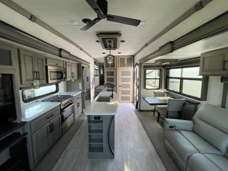 Keystone RV Montana 3781RL fifth wheel interior view with a slide-out, large kitchen with a kitchen island, counters, and stove